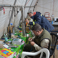 Geologists prepare a submersible pump for a pump test